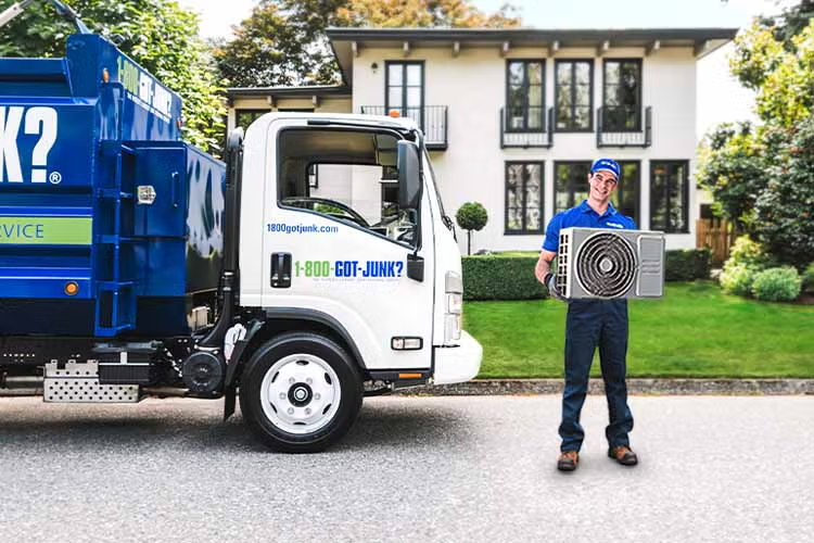 1800-GOT-JUNK? Truck Team Member hauling away an AC