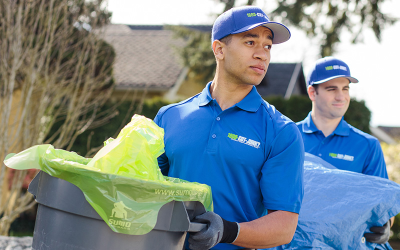 man holding rubbish bin